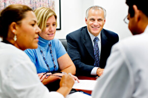 A group of people talking to each other